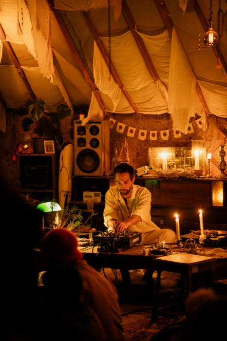 DJ set among candlelight and turntables at dusk