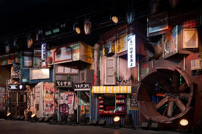 Full row of painted shanty facades under stage lighting