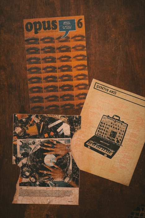 Vintage magazine and synth poster flatlay, backstage decor