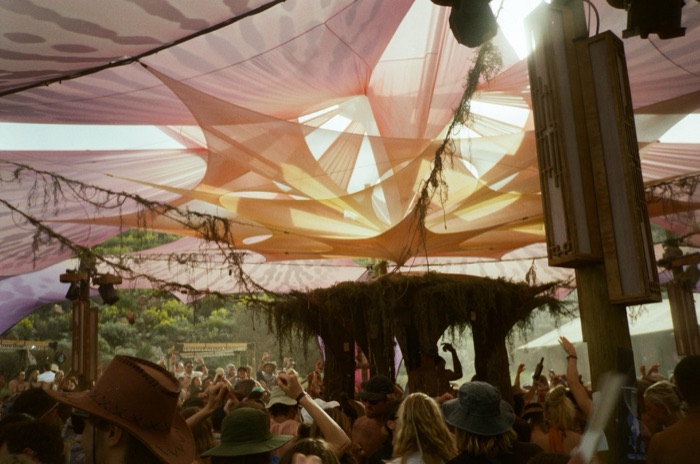 Sherbet-toned canopy folds catching daylight over the dance floor