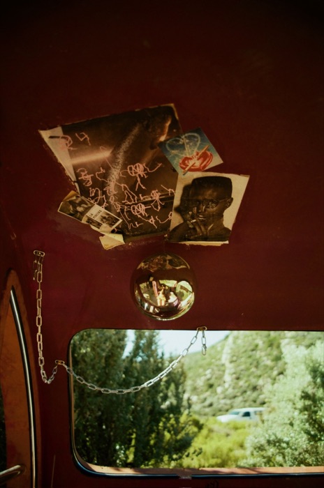 Collaged portraits and ephemera pinned to a trailer ceiling