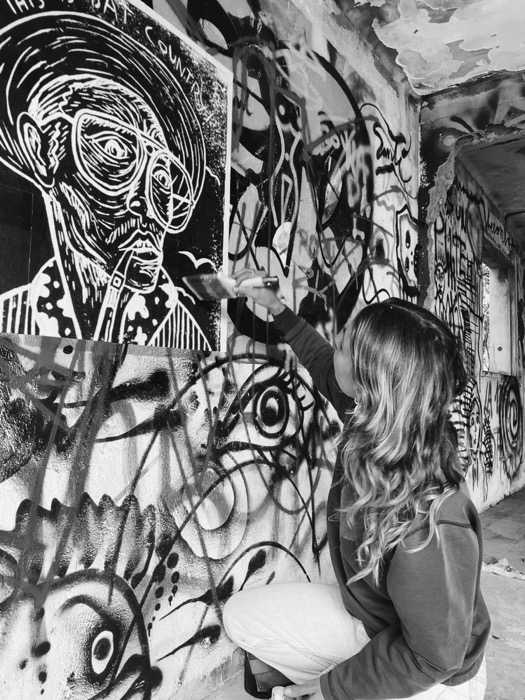 Pasting the Bat Country lino print detail onto the wall